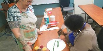 Instructor Sophia Edgett of Soo’s Chocolate & Bakery teaches a student cake decorating techniques. Intro to Buttercream, Embossed Fondant Cupcakes and Tall Cakes are just a few of the dozens of classes Craven CC’s Adult Enrichment Program is offering.